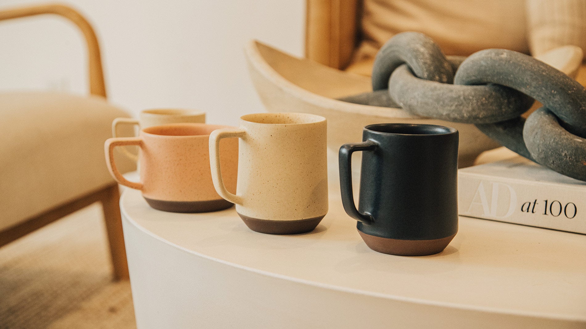 Multiple Mazama mugs on a circular coffee table.