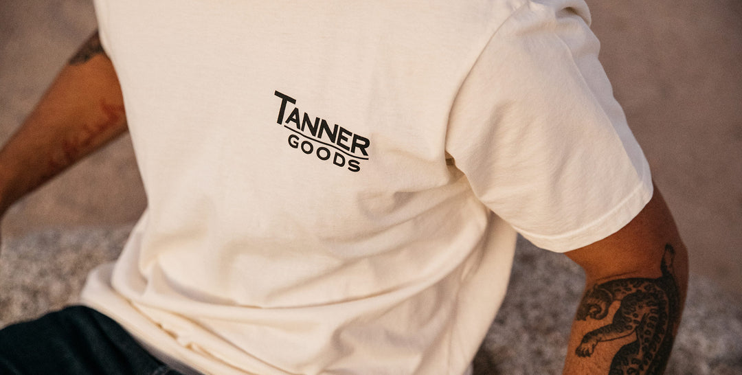 White t-shirt with Tanner Goods logo printed on the left chest. 