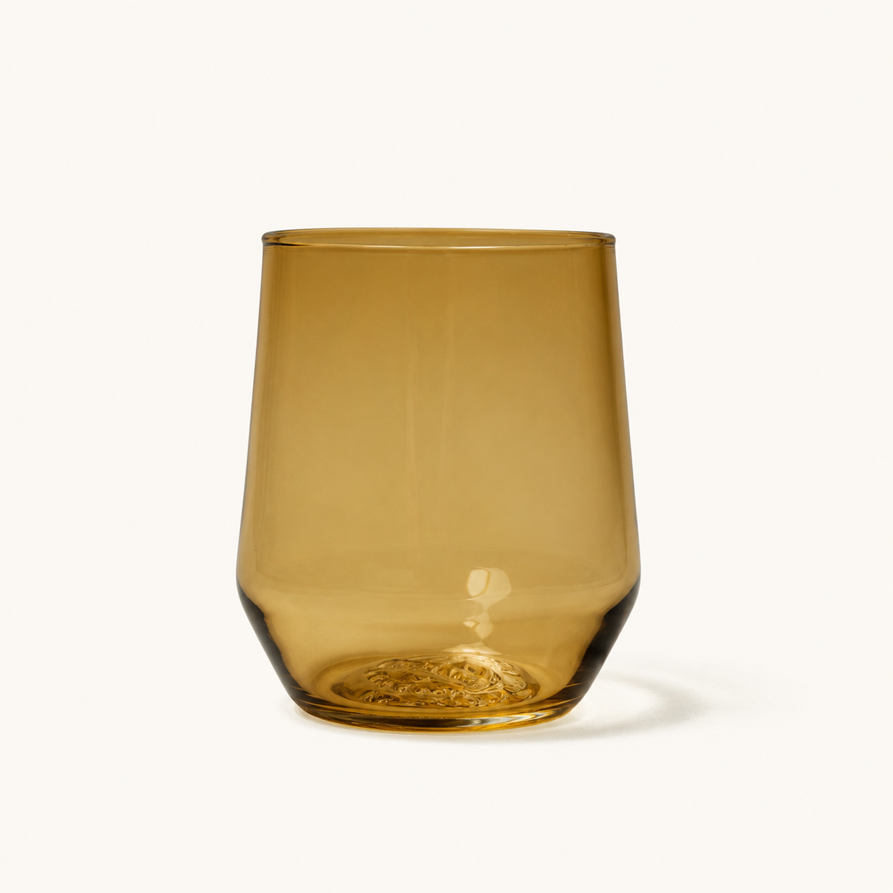 Amber-colored stemless wine glass with textured base, front view, clear glass material, smooth finish