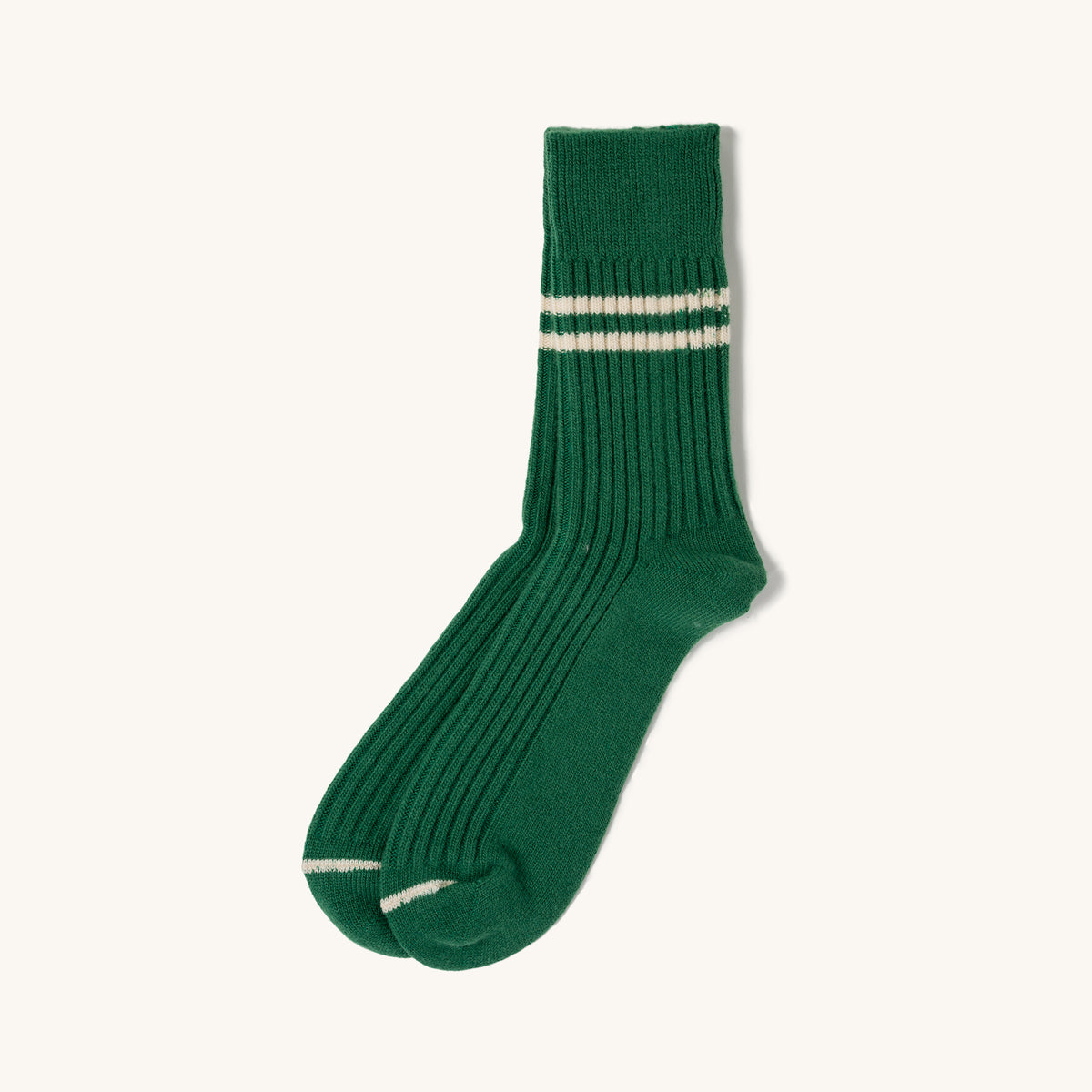 Green ribbed merino lambswool sock with white cuff stripes, shown against a cream background.