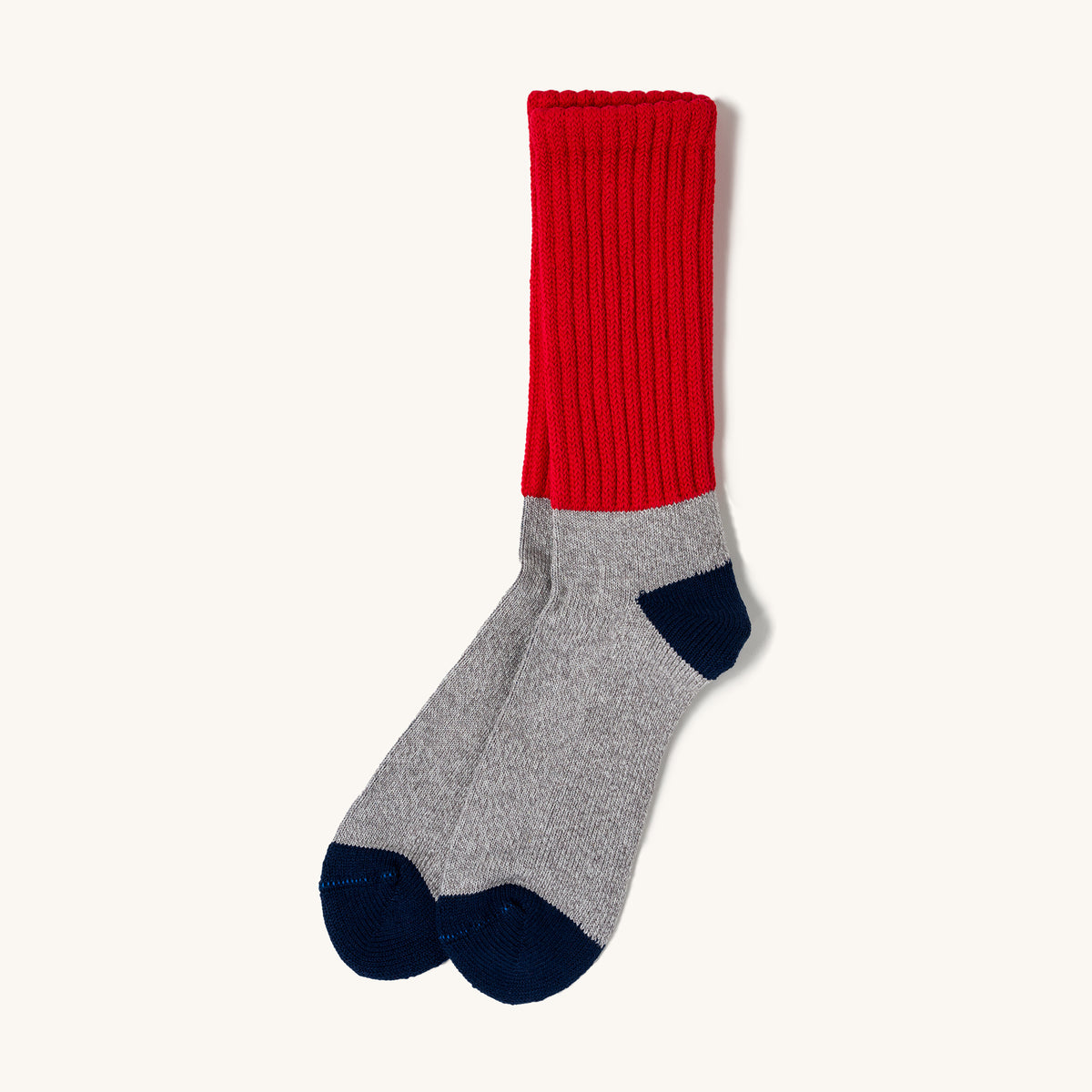 Red and gray ribbed loose pile socks with navy heel and toe, shown side view on white background.