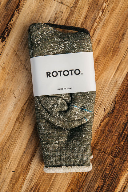Army green melange knit double face crew socks by ROTOTO, with fuzzy white lining, packaged on wood.