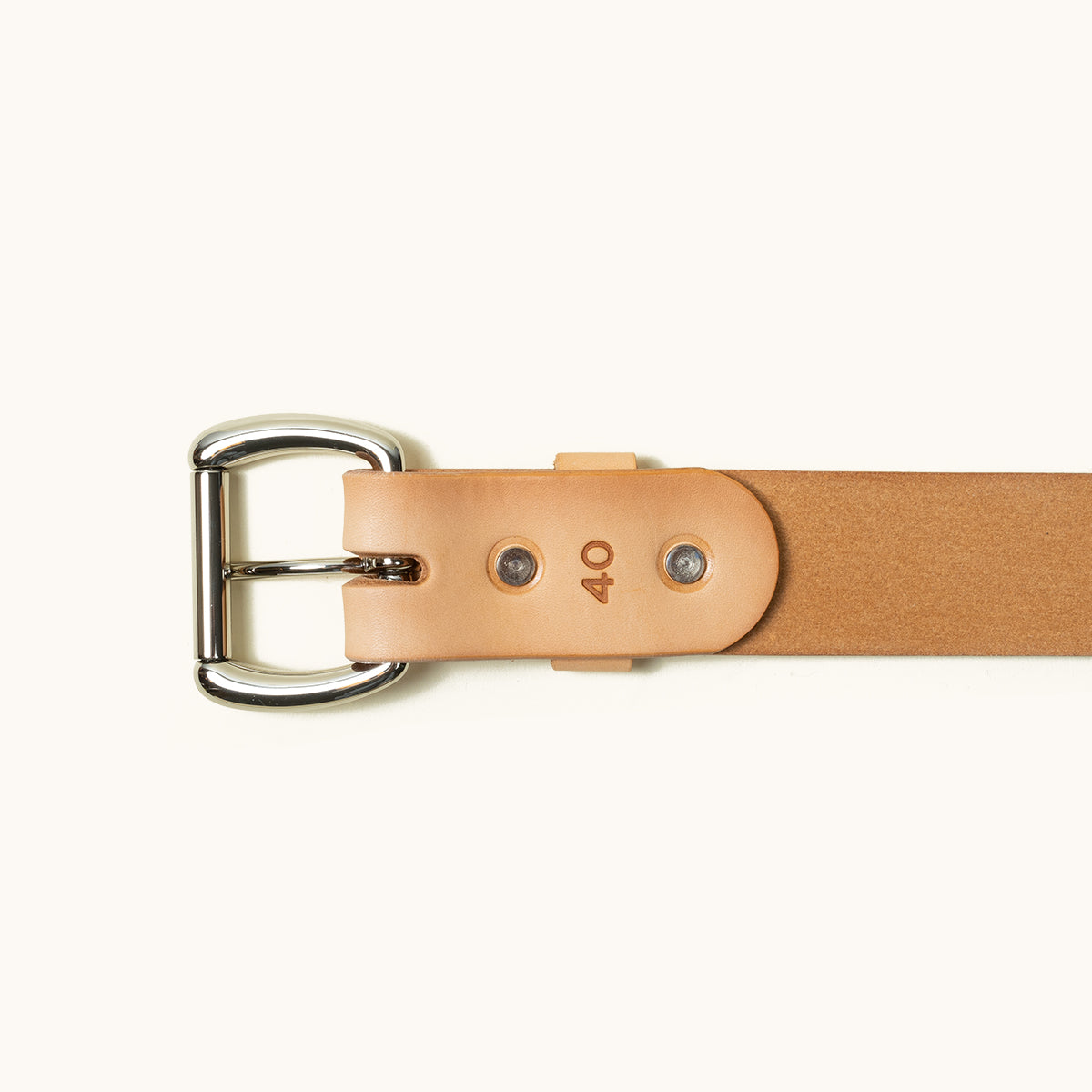 The bottom half of a Natural Standard belt showing a stainless roller ball buckle and two stainless rivets.