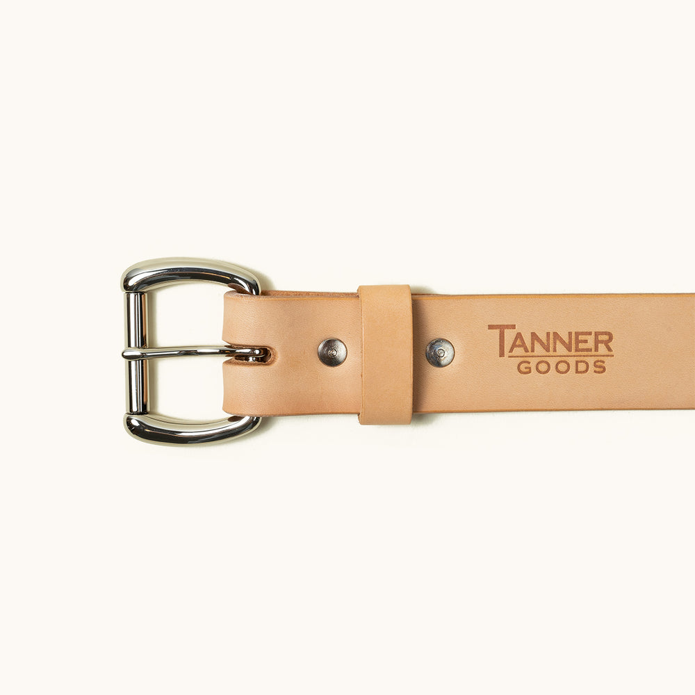 The top half of a Natural Standard belt showing a stainless roller ball buckle and Tanner Goods logo stamped into the belt.