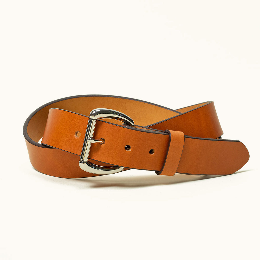 A coiled Saddle Tan leather belt with a stainless roller bar belt buckle.