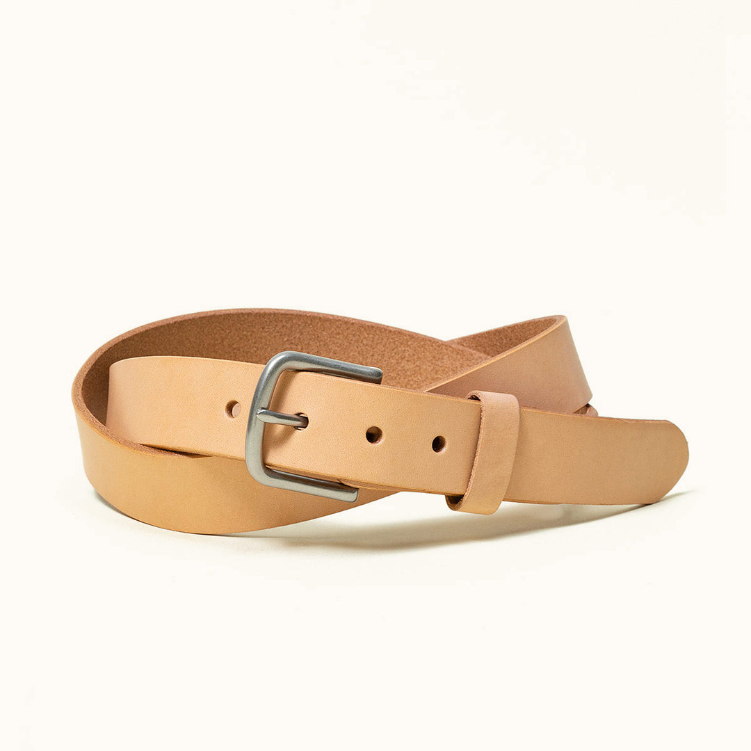 A natural leather belt that's coiled with a silver buckle.