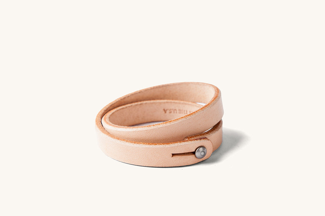 A double wrap natural leather wristband with metal closure.