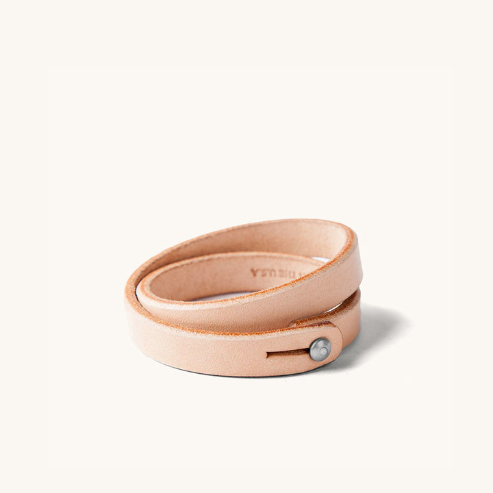 A double wrap natural leather wristband with metal closure.