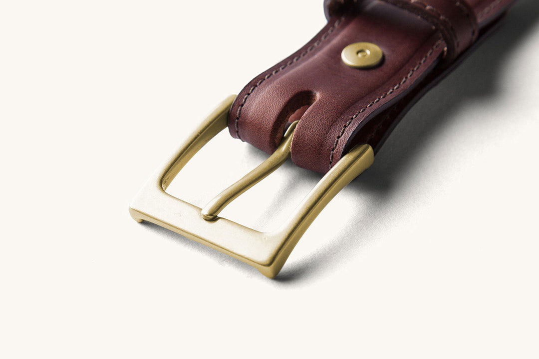 brass buckle on brown belt