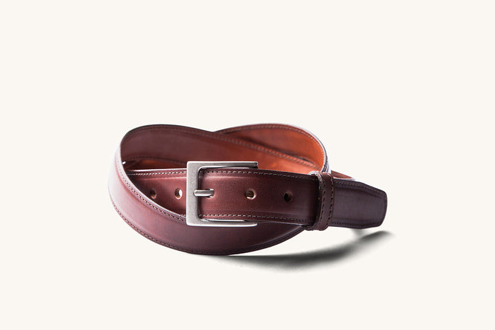 brown leather dress belt with silver buckle