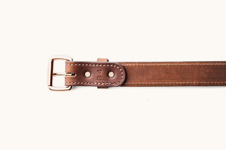 the underside of a size 34 brown leather belt with copper hardware