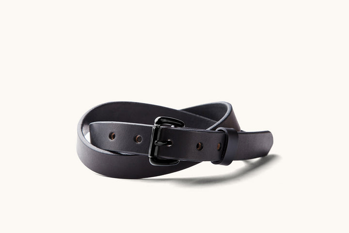 a skinny black leather belt with black roller buckle