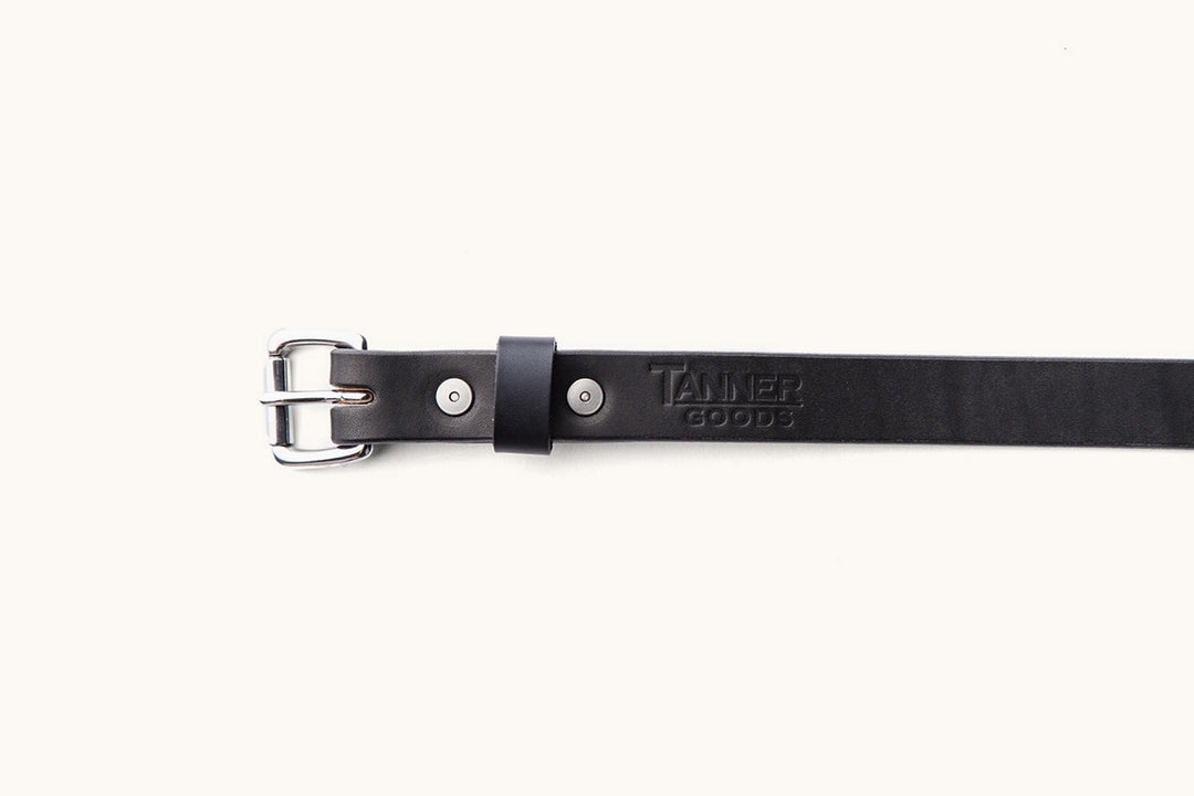 the first half of a Tanner Goods black leather belt with silver hardware and buckle