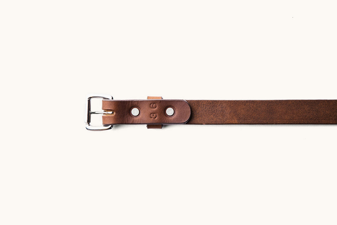 the underside of a size 36 brown leather belt with silver hardware