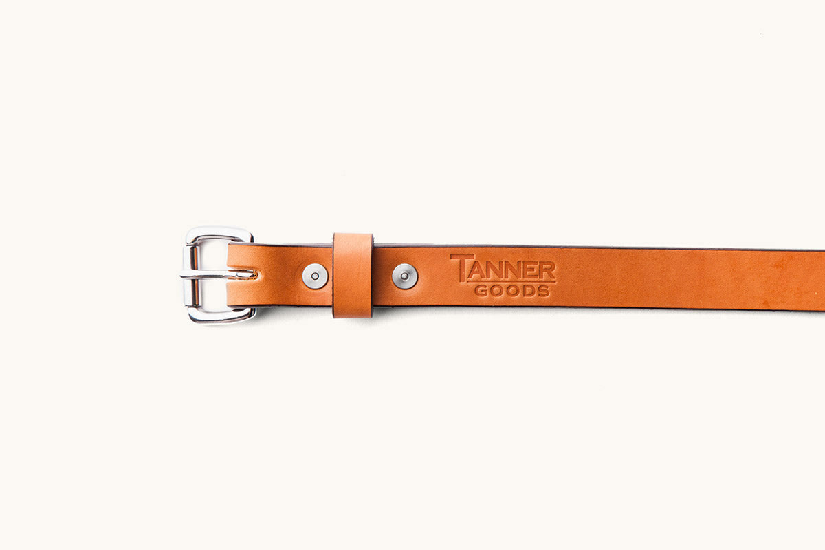 the front half of a Tanner Goods leather belt with silver hardware and monogrammed logo